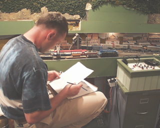 Yardmaster M. Keiser prepares paperwork for the next outbound.